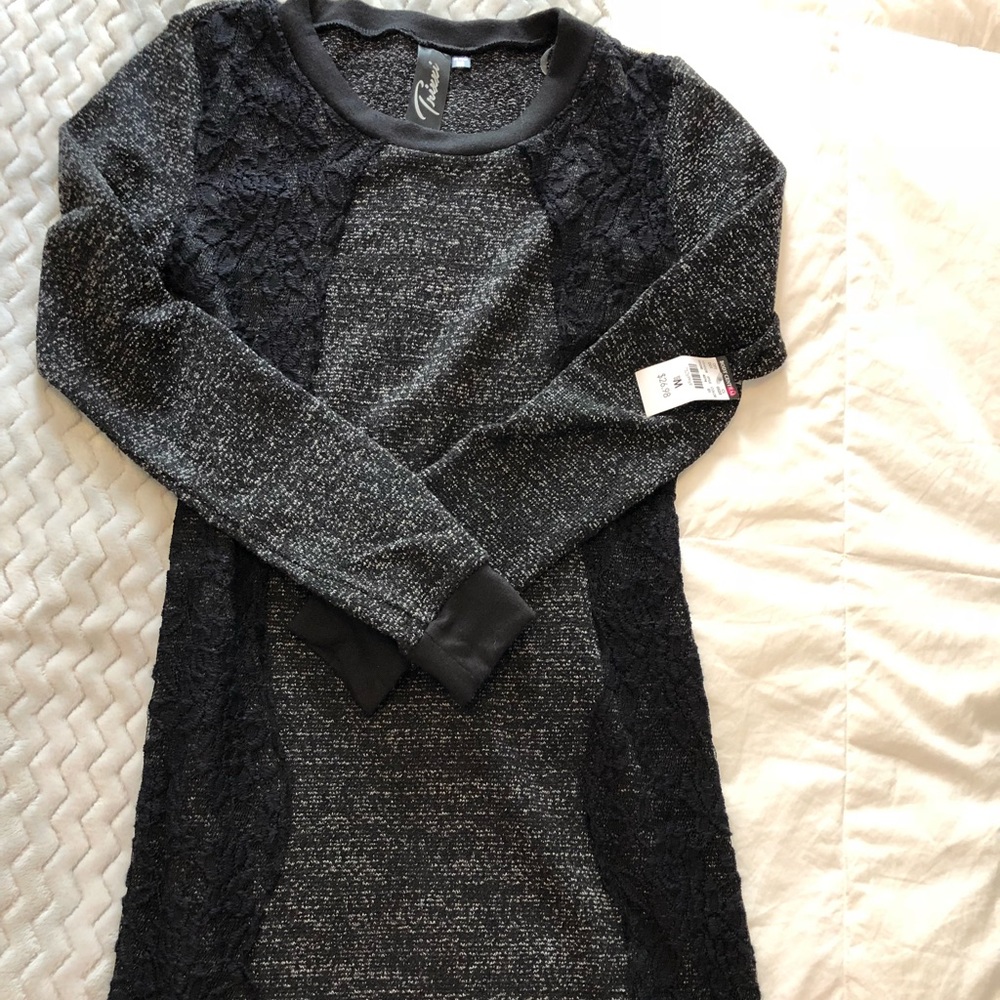 Black sweater dress with lace accents.